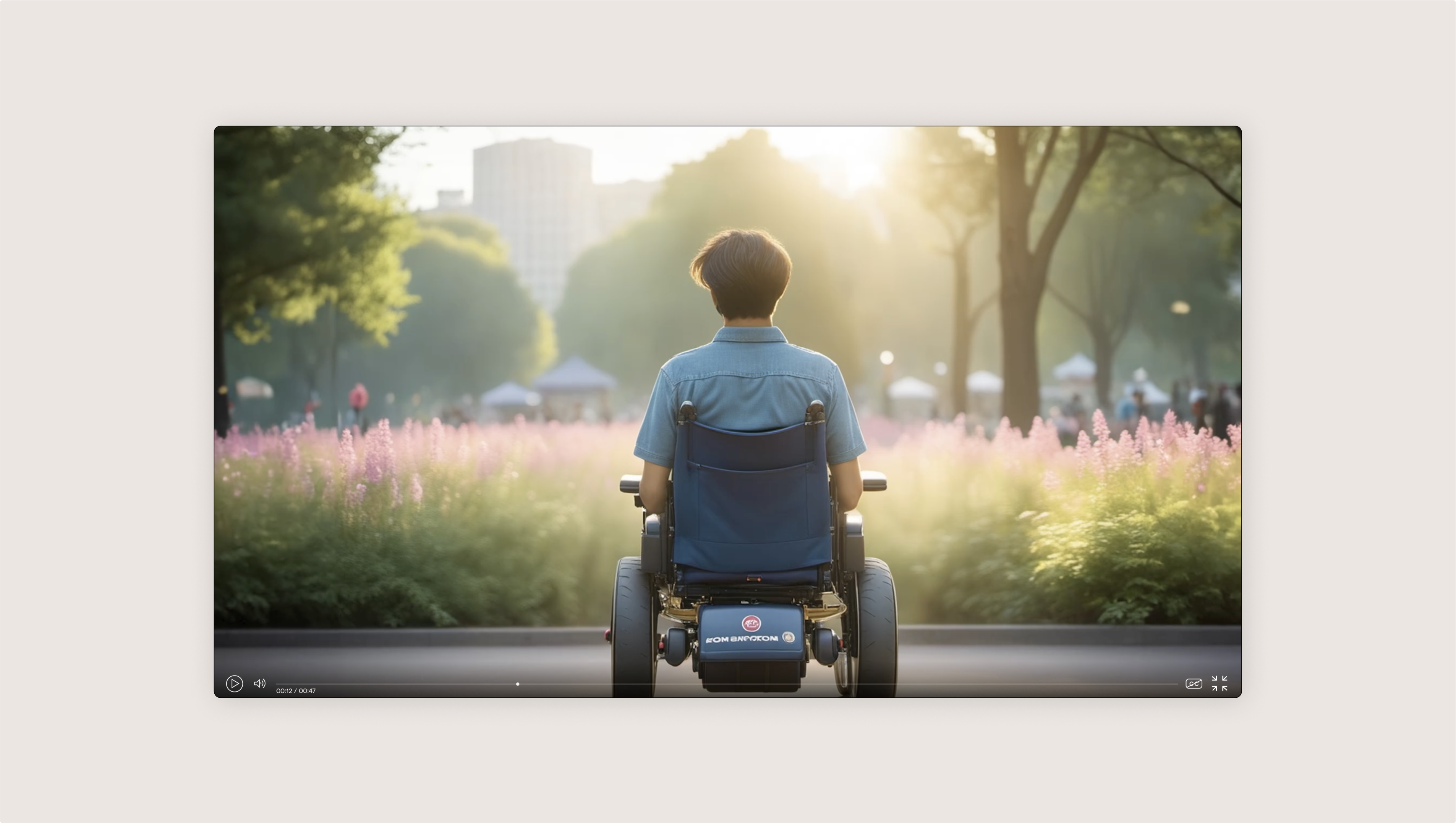 Cosmo shown in his electric wheelchair from the back overlooking a park.